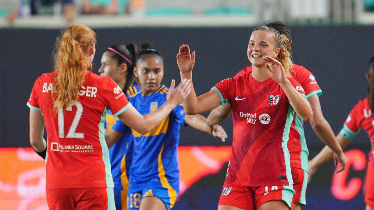 Kansas City Current midfielder Claire Hutton (right) celebrates with defender Stine Ballisager Pedersen (12) after their win against Tigres UANL at CPKC Stadium on Aug. 1, 2024.