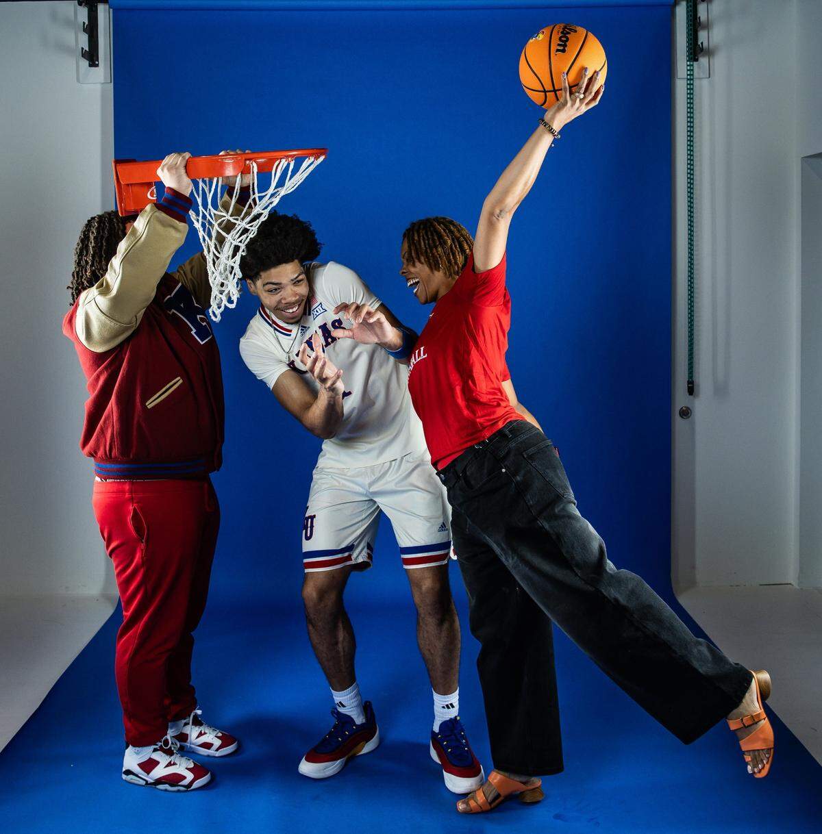 Tyran Stokes, center, laughs it up with his mom, Keaira Stokes, left, and cousin Malik Saunders during a photo shoot held as part of Tyran’s visit this week to the University of Kansas. Stokes is the No. 1 men’s basketball recruit in the nation for the 2026 high school recruiting class.