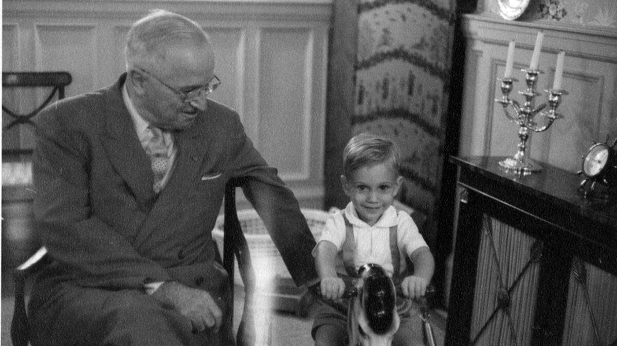 Former president Harry S. Truman with his grandson Clifton Truman Daniel during a Christmas visit. On the back of the photograph is a note: “Clifton Truman Daniel riding the rocking horse that Santa Claus brought him for Christmas 1959. When he fell off and started to bawl, former Captain Harry Truman, Battery D, 129th Field Artillery, issued a stern order: ‘Get back on the horse and ride ‘im.’ Clifton shut up and did as he was told.”