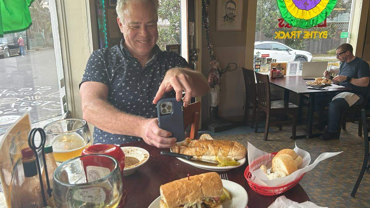 Ian McNulty, food critic for NOLA.com, photographs a po’boy sandwich at Liuzza’s by the Track, one of his favorite spots in the city.
