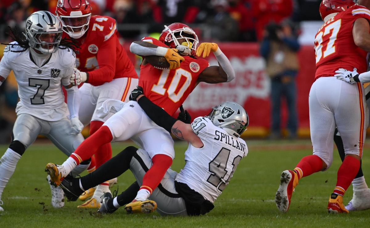 Kansas City Chiefs running back Isiah Pacheco (10) is pulled down by Las Vegas Raiders linebacker Robert Spillane (41) in the first quarter on Friday, Nov. 29, 2024, at GEHA Field at Arrowhead Stadium.