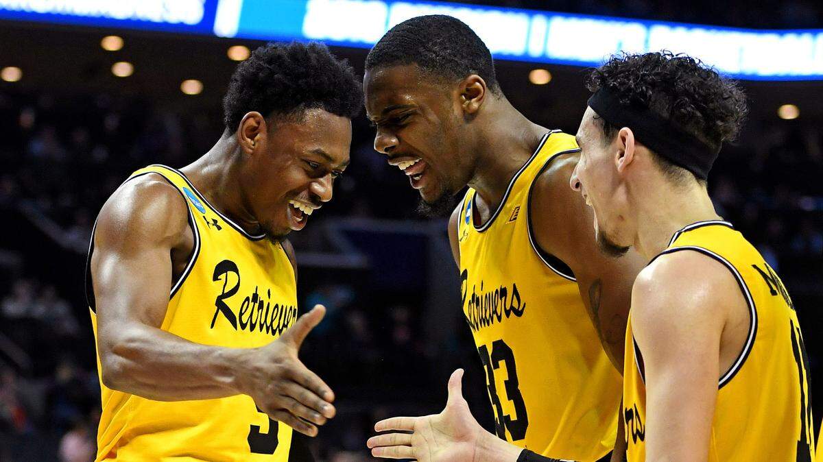 UMBC Retrievers guard Jourdan Grant (5) celebrates with guard K.J. Maura (11) and forward Arkel Lamar (33) during a stunning win over No. 1-seeded Virginia in the first round of the 2018 NCAA Tournament.