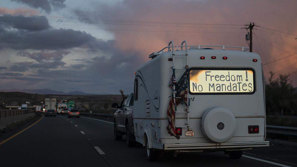 A trailer with the words “Freedom! No Mandate” on its back window travels with a trucker caravan heading toward Washington, D.C., to protest COVID-19 mandates.