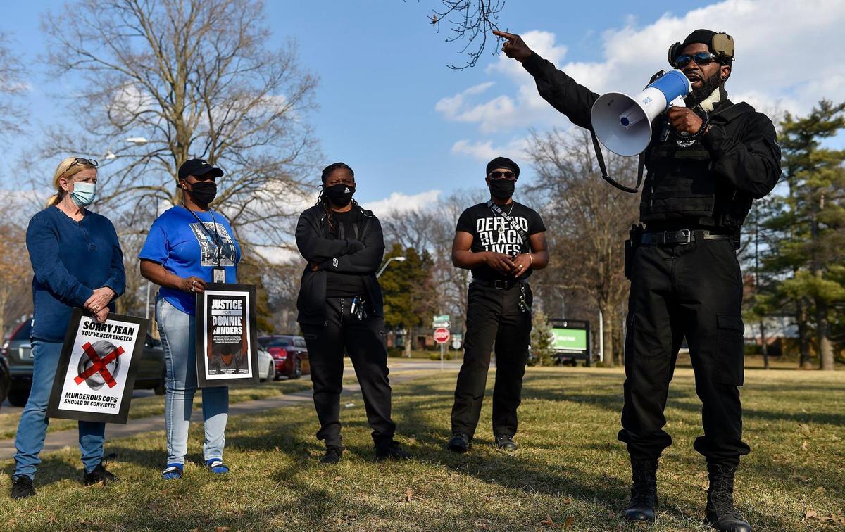 Several dozen people joined family members of Donnie Sanders to march for justice. The Jackson County Prosecutor’s Office said there was insufficient evidence to charge Officer Blayne Newton, who fatally shot Sanders in March last year. The march started at Arno Park at Ward Parkway and W. 69th Street, where General Indigenous Xi, right, with Revolutionary Black Panther Party of KC, spoke. Sanders’ sisters, Reshonda Sanders, from second left, Youlanda Sanders and march organizer Anton Washington listen.