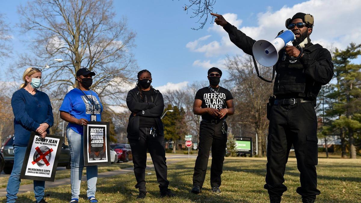 Several dozen people joined family members of Donnie Sanders to march for justice. The Jackson County Prosecutor’s Office said there was insufficient evidence to charge Officer Blayne Newton, who fatally shot Sanders in March last year. The march started at Arno Park at Ward Parkway and W. 69th Street, where General Indigenous Xi, right, with Revolutionary Black Panther Party of KC, spoke. Sanders’ sisters, Reshonda Sanders, from second left, Youlanda Sanders and march organizer Anton Washington listen.