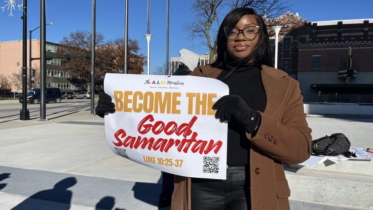 Carrington Allen, founder of AIM Ministries, holds up her sign at a rally Wednesday morning to protest against the ordinance which penalizes camping.
