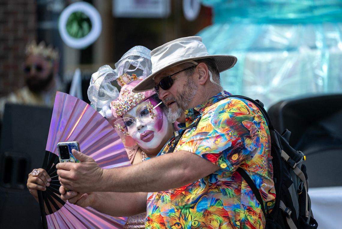 Hunny Bunches of Oates of the City of Fountain Sisters, modern order of 21st century queer nuns, has a selfie taken with David Shelton of Planned Parenthood Great Plains at the KC Pride Parade.