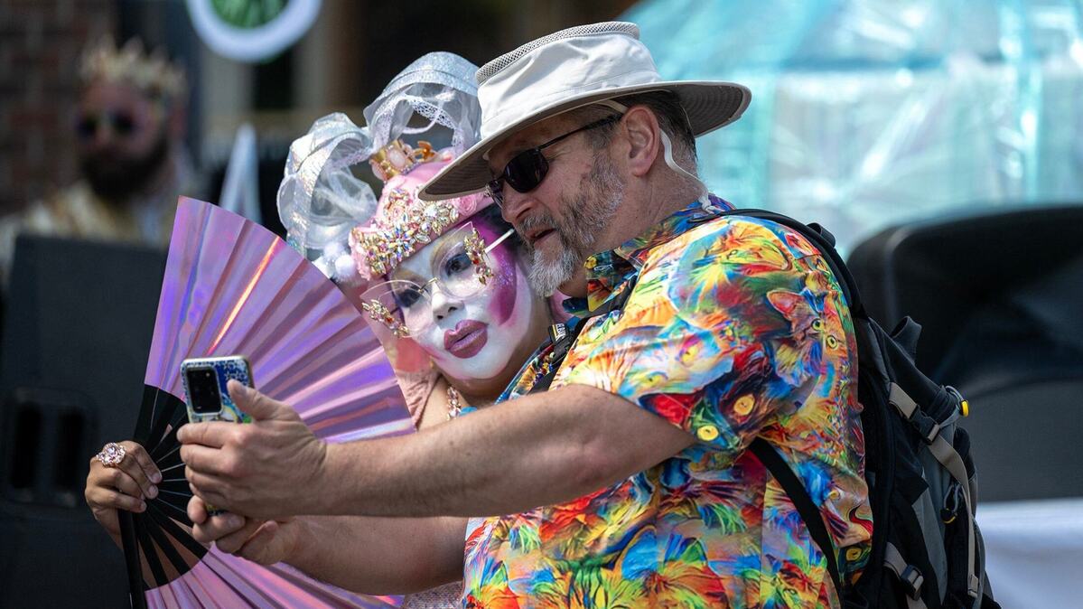 Hunny Bunches of Oates of the City of Fountain Sisters, modern order of 21st century queer nuns, has a selfie taken with David Shelton of Planned Parenthood Great Plains Saturday at the KC Pride Parade in Kansas City.
