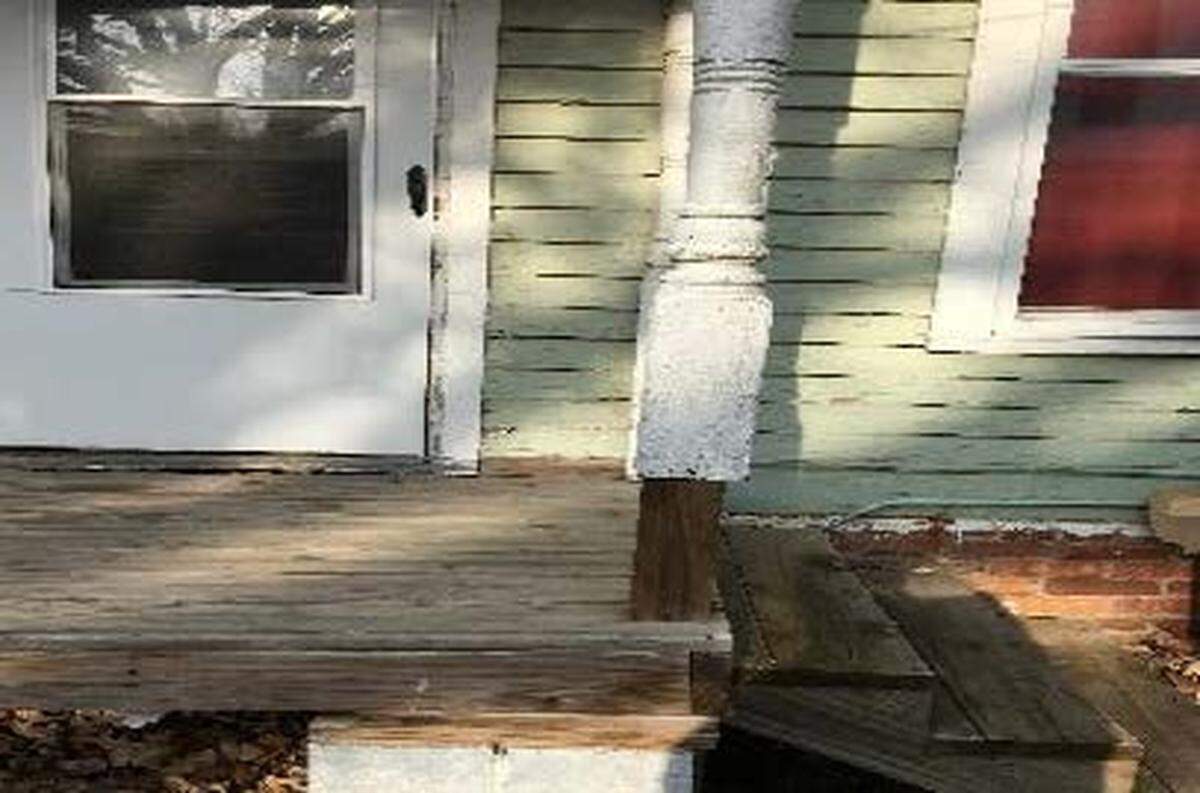 This photo shows a load-supporting column supported with a wooden block.