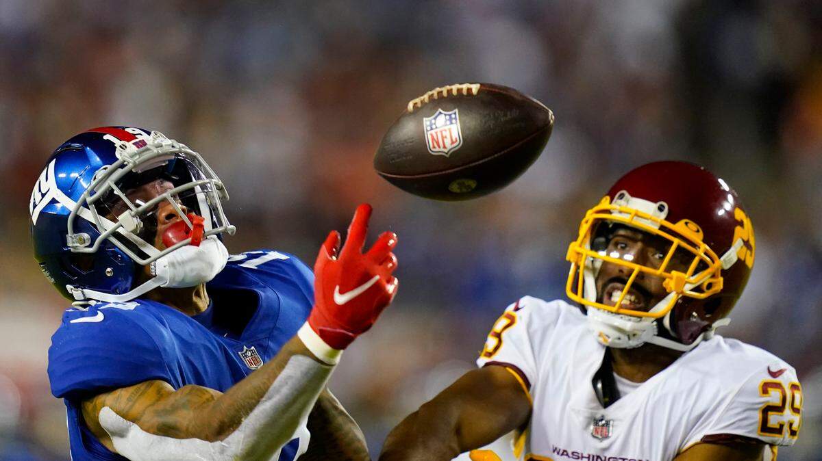 New York Giants wide receiver Kenny Golladay (19) looses control of the ball while being covered by Washington Football Team cornerback Kendall Fuller (29) during the second half of an NFL football game, Thursday, Sept. 16, 2021, in Landover, Md. (AP Photo/Patrick Semansky)