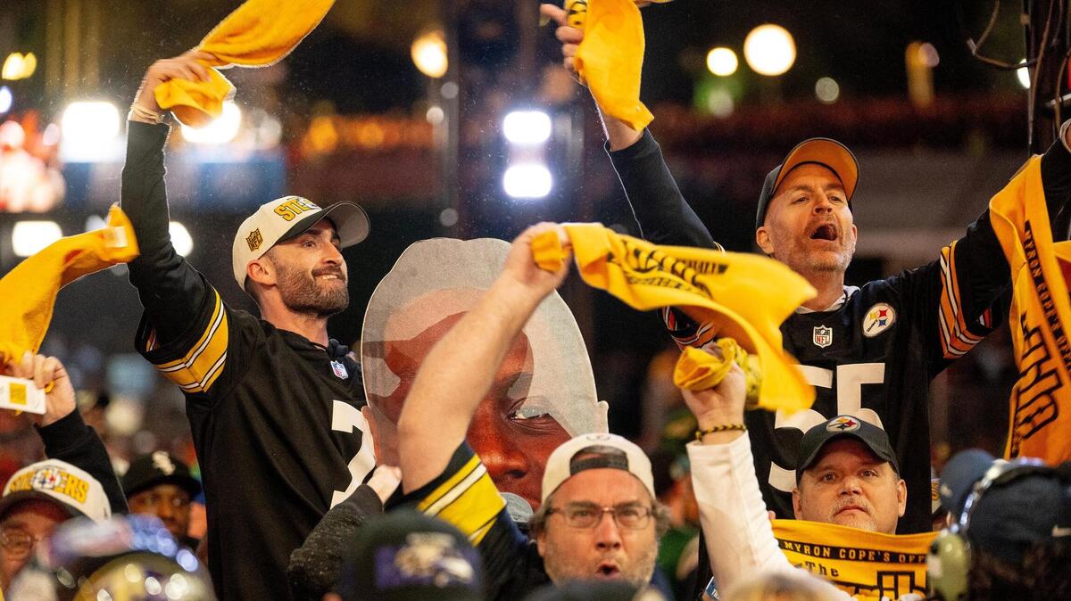Pittsburgh Steelers fans celebrate their first round pick of Georgia offensive tackle Broderick Jones during the NFL Draft outside of Union Station on Thursday, April 27, 2023, in Kansas City.