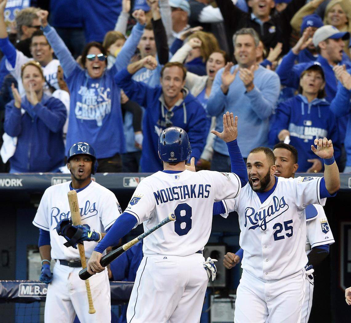Kansas City Royals third baseman Mike Moustakas celebrates at the dugout with teammates after he was driven in for the go ahead run in the seventh inning by left fielder Alex Gordon during Saturday’s ALCS baseball game on October 17, 2015 at Kauffman Stadium in Kansas City, Mo.
