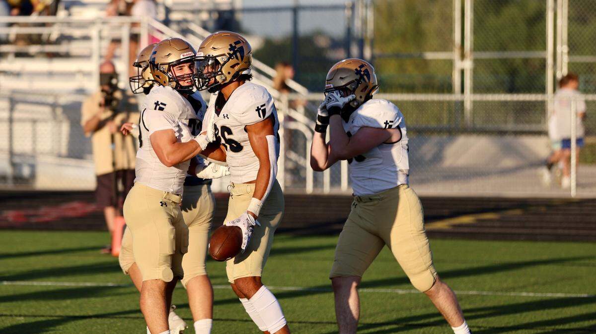 Elzie Slaughter celebrates with Saints teammates after a 20-yard touchdown run vs Blue Valley West