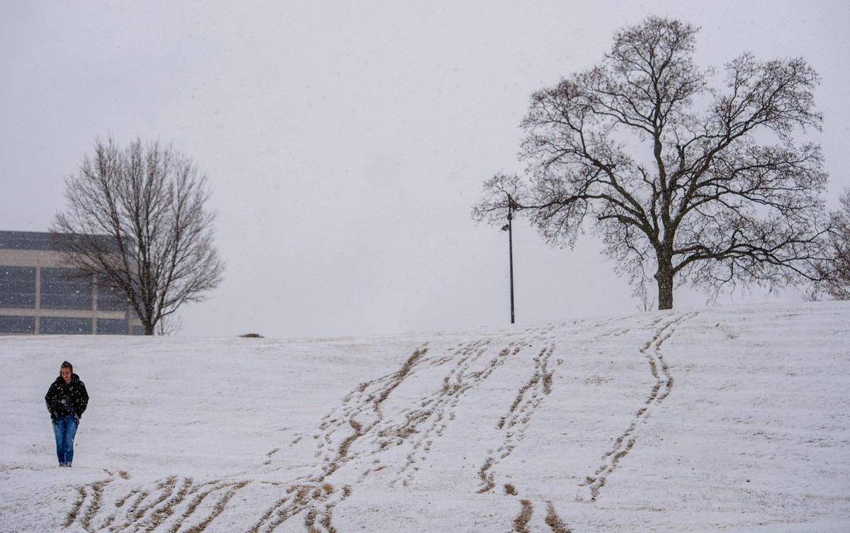 A walker traversed a slope at Penn Valley Park during a snow storm Saturday, Feb. 6, 2021 in Kansas City.