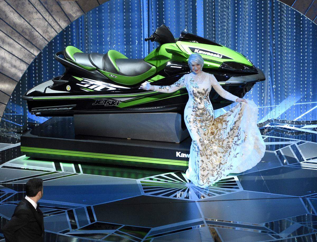 Helen Mirren displays a jet ski as host Jimmy Kimmel looks on, left, at the Oscars on Sunday, March 4, 2018, at the Dolby Theatre in Los Angeles. (Photo by Chris Pizzello/Invision/AP)