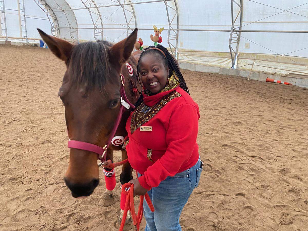 Board member and volunteer Carole Irangi hangs out with Maiden