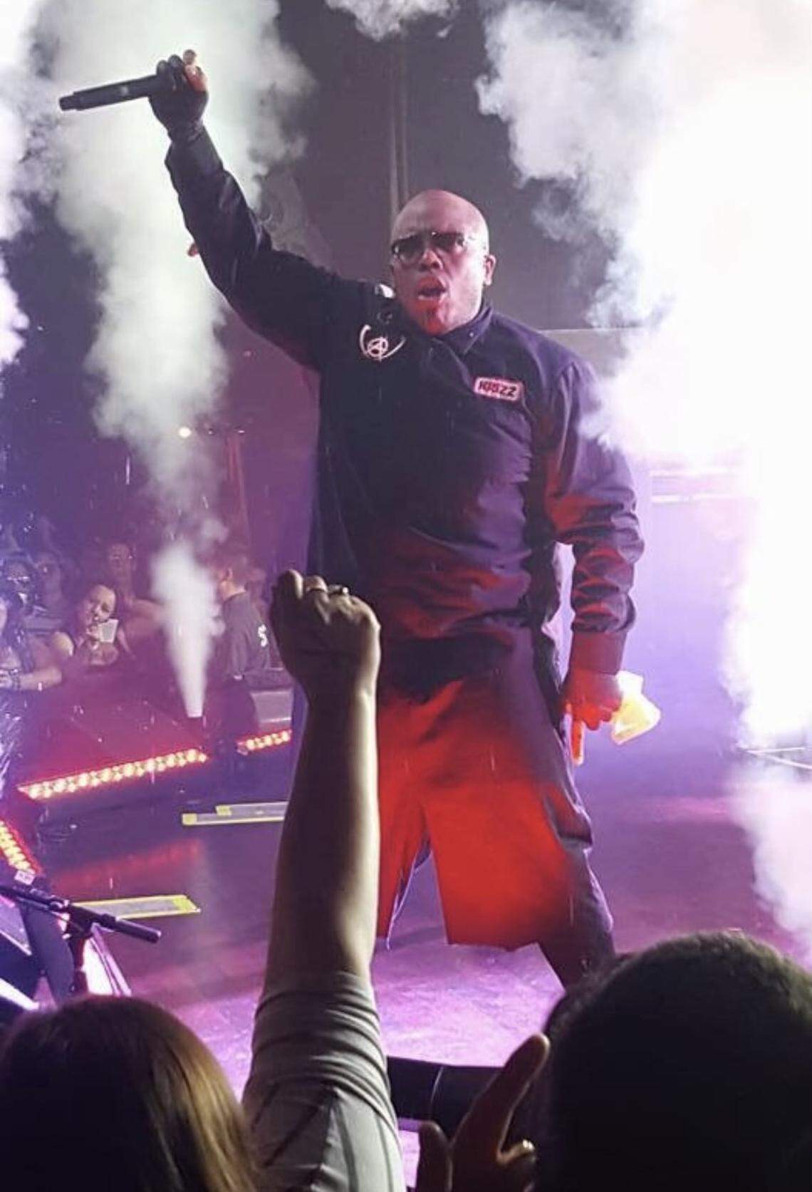 Samuel Watson, aka Kansas City rapper Krizz Kaliko, performing on stage to a packed crowd of fans.
