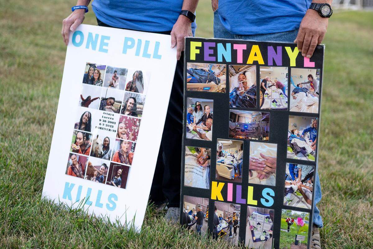 Sharen and Lee Lucero, the parents of Jetaya Lucero, hold posters featuring photos of their daughter on Thursday, Sept. 14, 2023, at a soccer game in Shawnee, Kansas. Jetaya died from fentanyl in Lawrence at age 19.