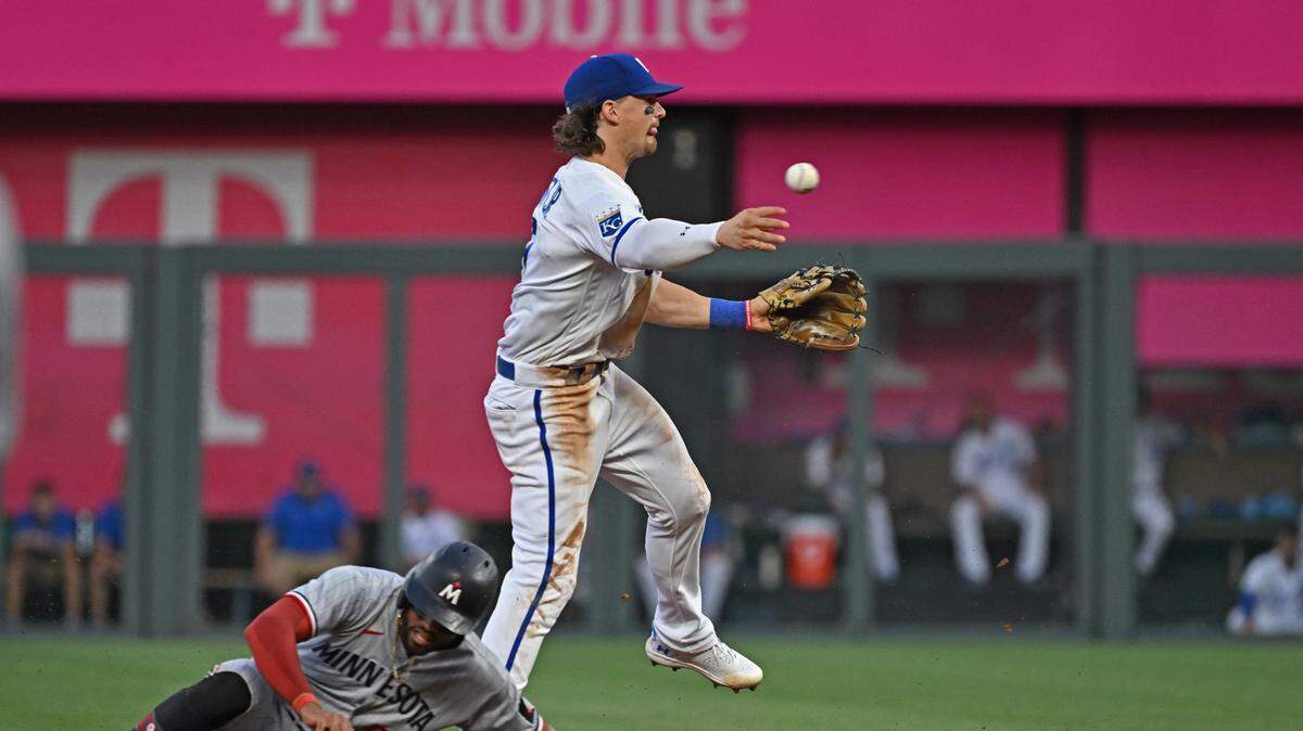 Kansas City Royals shortstop Bobby Witt Jr. (7) completes a double play against Minnesota Twins center fielder Willi Castro during the sixth inning at Kauffman Stadium on July 29, 2023.