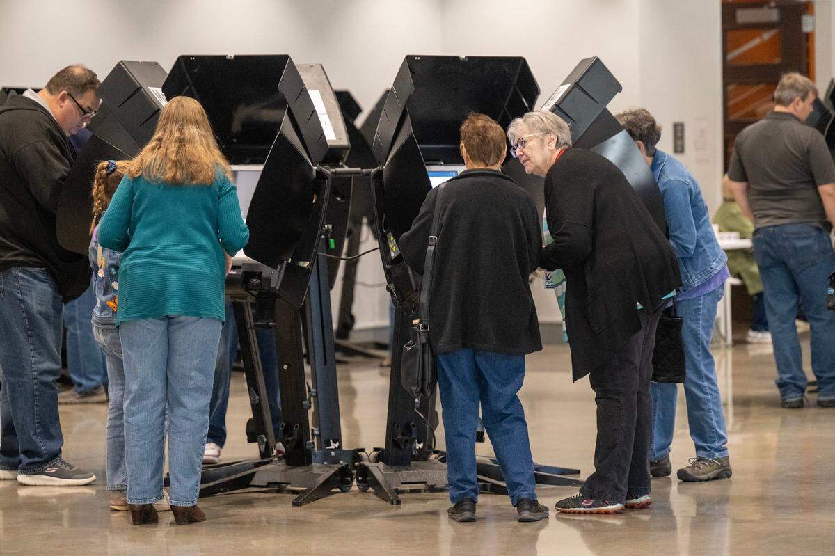 Voters cast their ballots on the first day of in-person advanced voting in Johnson County at the Arts and Heritage Center in Overland Park on Oct. 19, 2024.