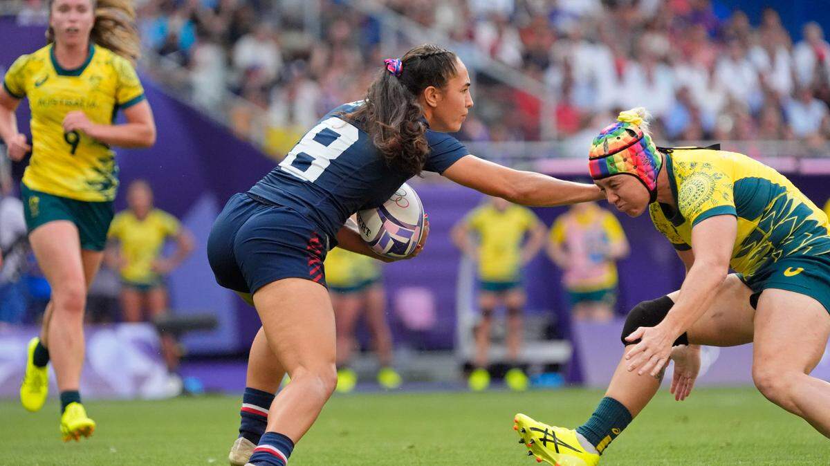 United States back Alex Sedrick (8) runs with the ball against Australia forward Sharni Smale (2) in the bronze medal match during the Paris 2024 Olympic Summer Games at Stade de France.