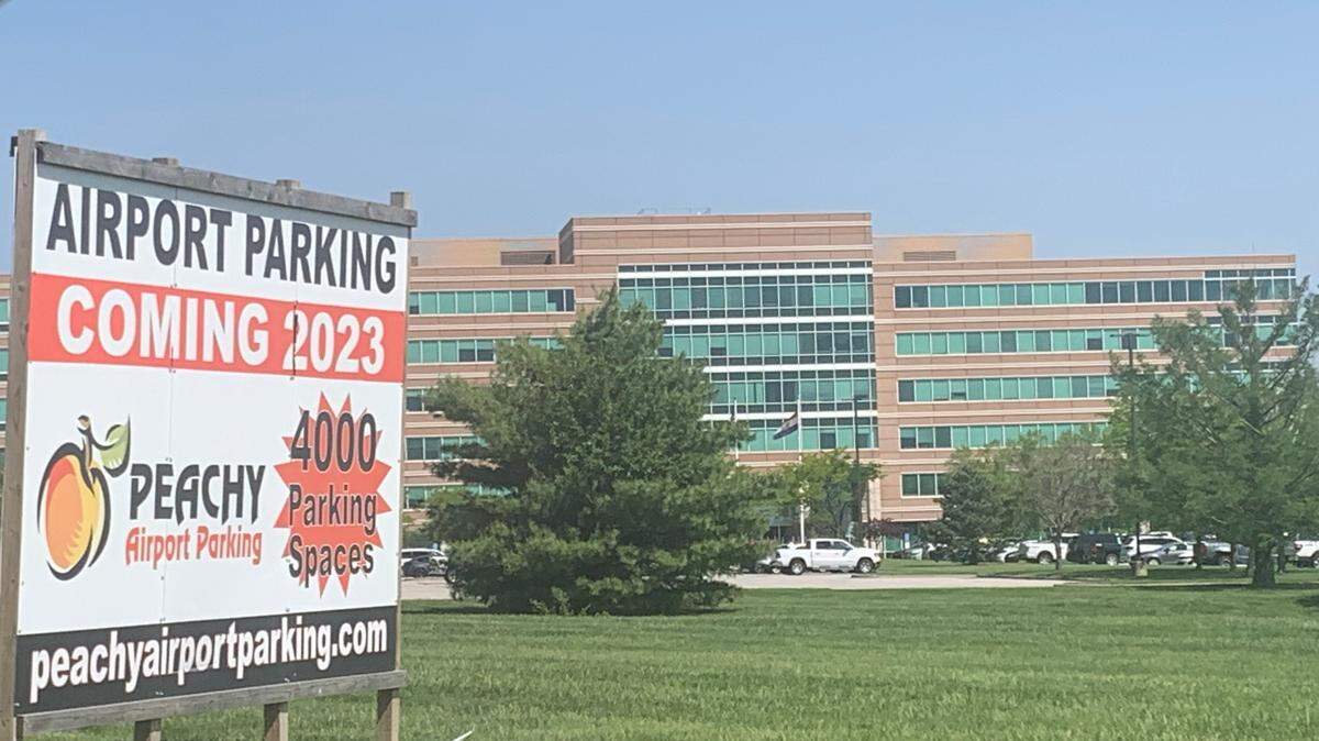 A sign in front of the Ambassador Building, 12200 N. Ambassador Drive in Kansas City, touts the Peachy Airport Parking operation planned by developer Richard Chaves, Jr.