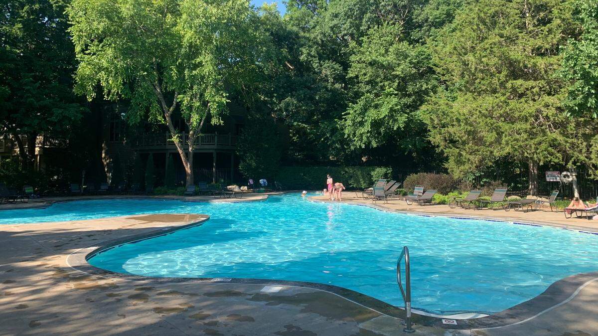 The pool behind the clubhouse at Olathe’s Cedar Creek development is pictured here. Residents say their children have been injured and fallen ill after swimming in the pool, which was shut down by a Johnson County official this week.