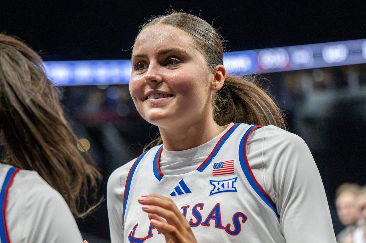 Kansas Jayhawks guard Elle Evans (21) smiles while walking off the court after KU defeated the UCF Knights 56-35 in a Big 12 Women's Basketball Tournament game inside Kansas City’s T-Mobile Center on Wednesday, March 4, 2026.