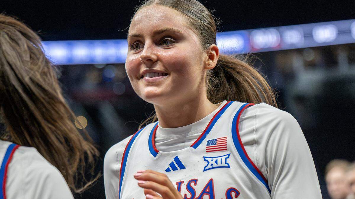 Kansas Jayhawks guard Elle Evans (21) smiles while walking off the court after KU defeated the UCF Knights 56-35 in a Big 12 Women's Basketball Tournament game inside Kansas City’s T-Mobile Center on Wednesday, March 4, 2026.