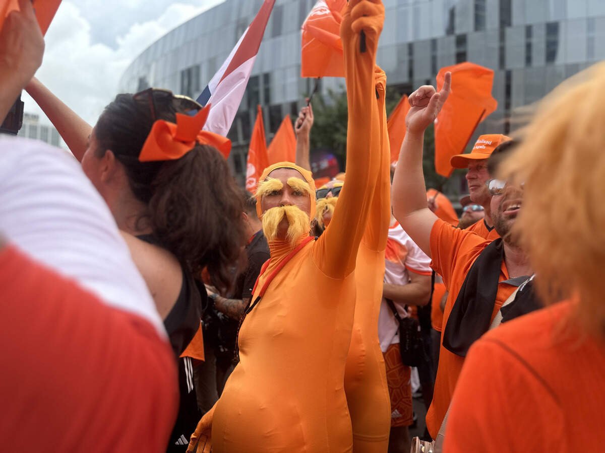 Baylie Perry and Maddie Roberts wave a flag dressed as the Lorax before the fanwalk begins. They’ve had the outfits for a long time, and it is not their first public outing as Loraxes.