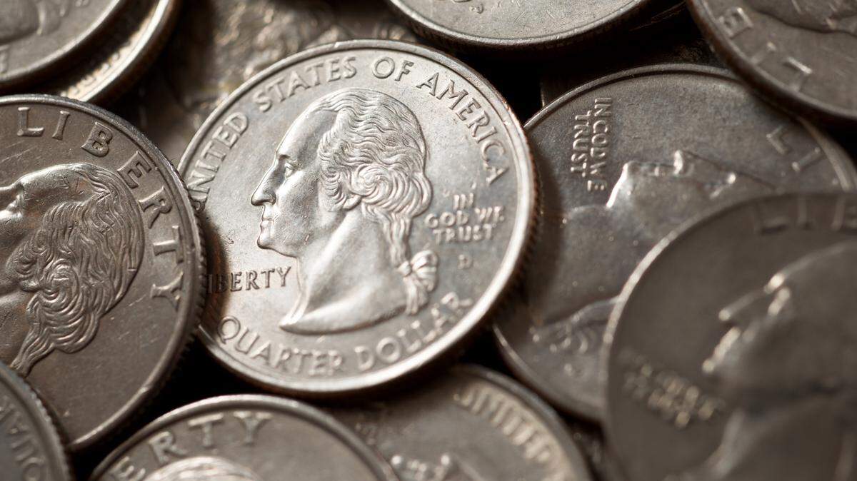 Quarter dollar coins on a black table