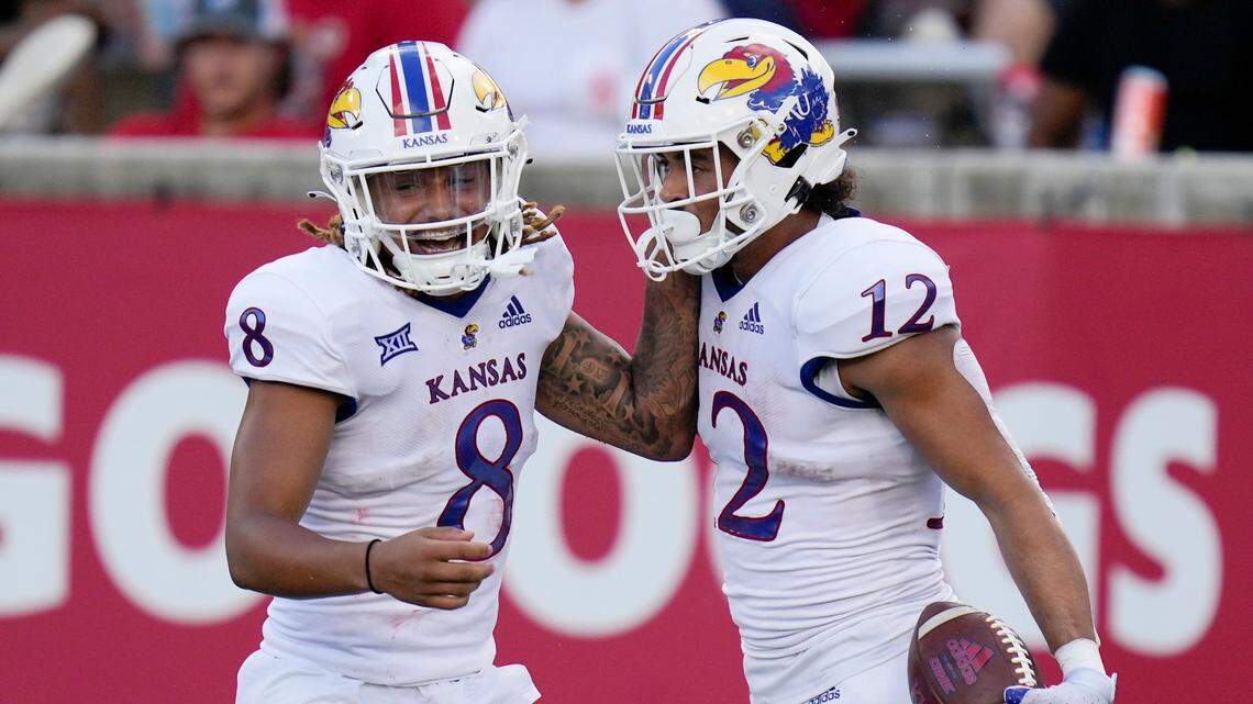 Kansas running back Torry Locklin (No. 12) celebrates his touchdown against Houston Saturday with Jayhawks teammate Ky Thomas in Houston. (AP Photo/Eric Christian Smith)