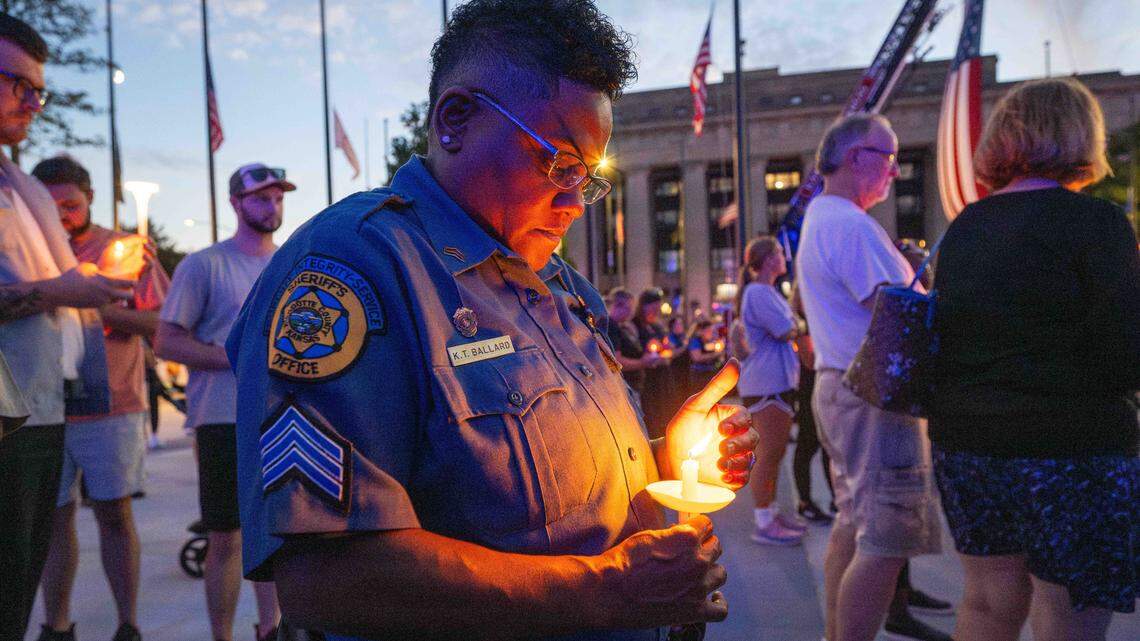 Officer K.T. Ballard of Wyandotte County Sheriff’s office holds a candle for slain KCKPD officer Hunter Simoncic at a candlelight vigil in his honor, on Thursday, Aug. 28, 2025, in Kansas City, Kansas.