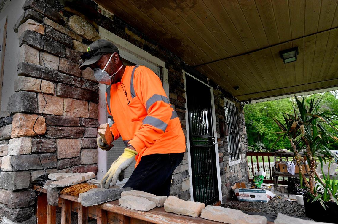 Marlon Hammons, president of the Washington-Wheatley Neighborhood Association, completes stone work on the front of his own house. The neighborhood, bounded on the north by the 18th and Vine District and on the south by 27th Street, is pockmarked with vacant buildings but Hammons and others are rehabbing houses to help improve the area.