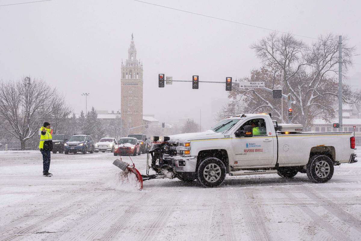 Crew members from the KC Streetcar plow snow along the tracks near the Country Club Plaza as snow blankets the Kansas City metro area on Monday, Dec. 1, 2025. The area is expected to accumulate 3 to 5 inches.