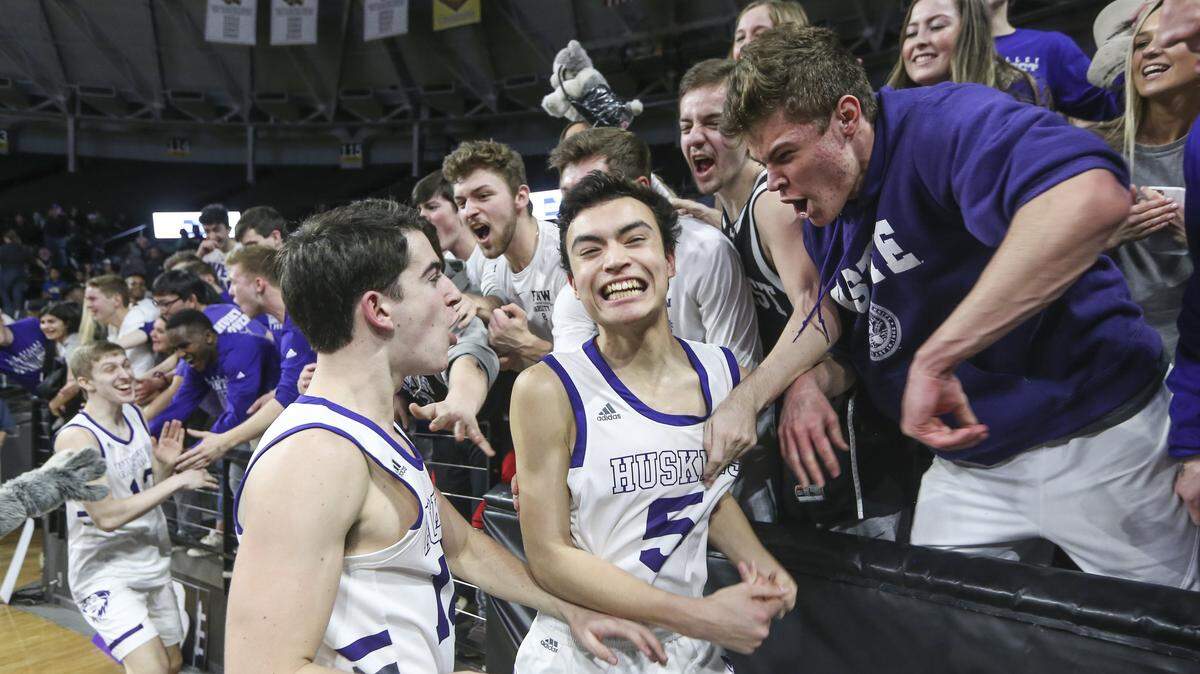 Blue Valley Northwest’s Nathan Burger celebrates with fans after the Huskies staged a fourth-quarter comeback to down Shawnee Mission South during their Class 6A semifinal game at Koch Arena in Wichita.