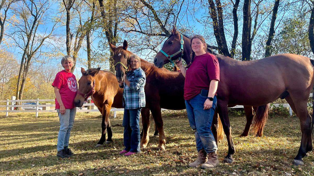 Cheryl Steffen (left), Deanna Aikin and Tori O-Dell, from Nikia Valley Equine in the 10000 block of Bannister Road, stand with horses April (left), Nikia and Inb. The women evacuated 11 horses Sunday, Oct. 23, 2022, after a grass fire ignited off Interstate 470 Highway in south Kansas City, putting the barn and the horses at risk.