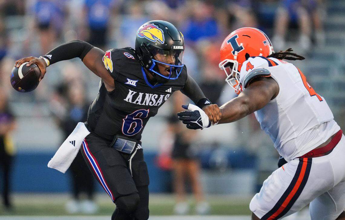 Kansas Jayhawks quarterback Jalon Daniels (6) scrambles away from Illinois defensive lineman Jer’Zhan Newton (4) during the first half at David Booth Kansas Memorial Stadium on Sept. 8, 2023.