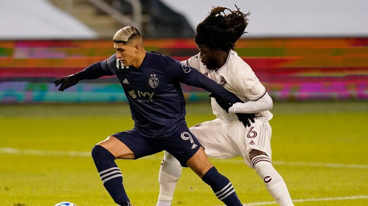 Colorado Rapids defender Lalas Abubakar (6) guards against Sporting Kansas City forward Alan Pulido (9) during the first half of an MLS soccer match in Kansas City, Kan., Saturday, Oct. 24, 2020. (AP Photo/Orlin Wagner)