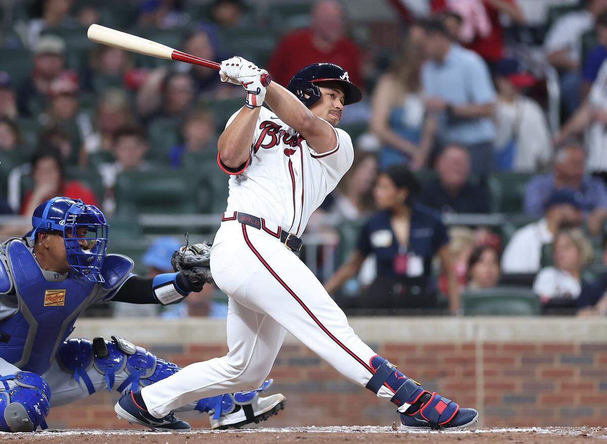 Braves designated hitter Drake Baldwin belts a solo home run off Kansas City Royals starting pitcher Cole Ragans (not pictured) during the third inning of both teams’ MLB season opener at Truist Park in Atlanta on Friday, March 27, 2026. At left, catching, is KC’s Salvador Perez.