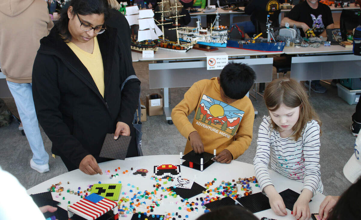 Olathe residents Sahiti Galla, Shawn Gollapalli, 7, and Hannah Schmidt, 6, take the chance to get hands-on with Legos at the KC Brick Lab Showcase Feb. 24.