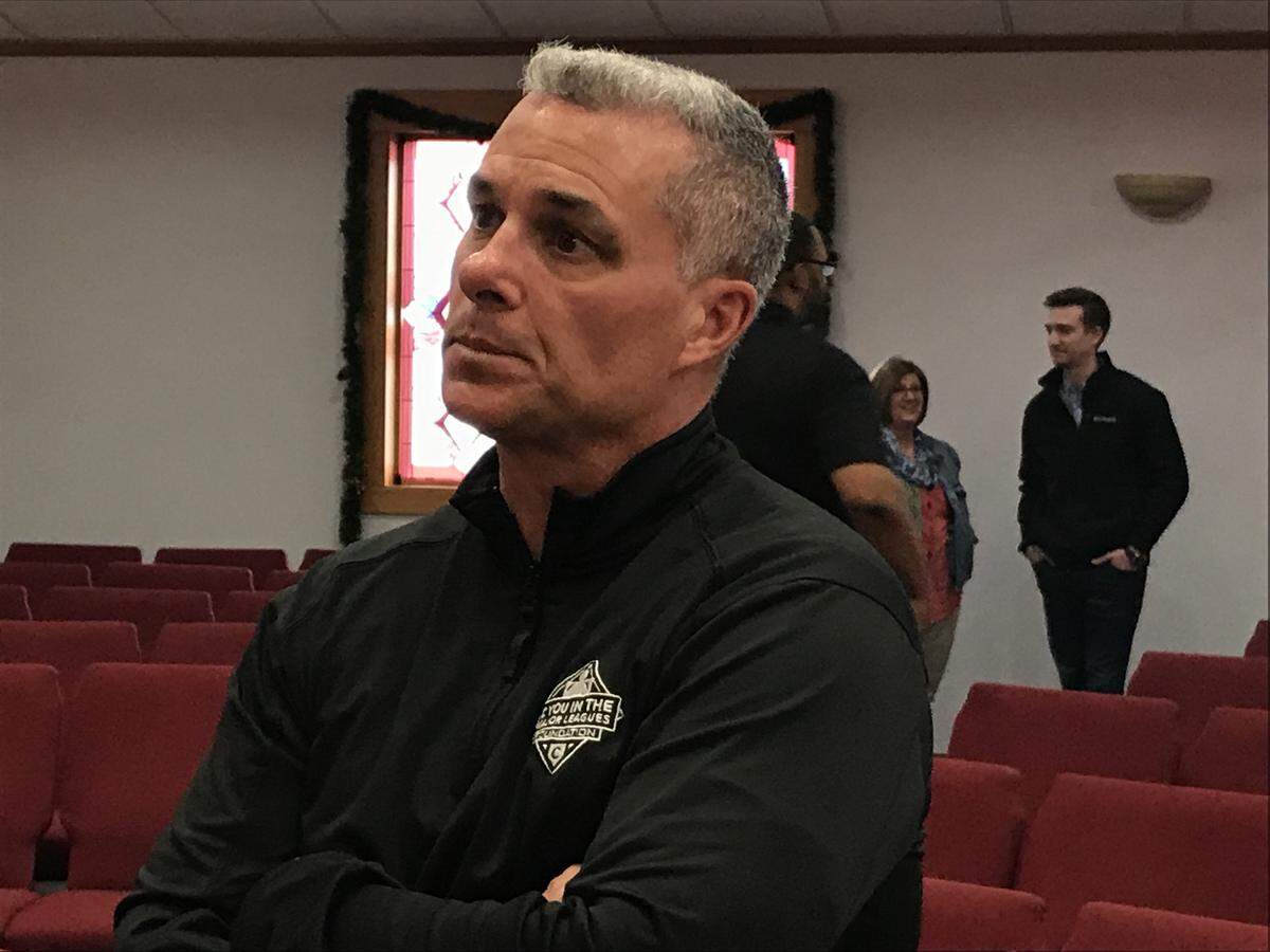 Royals manager Dayton Moore listens during one of his prison-ministry trips through the Heartland.