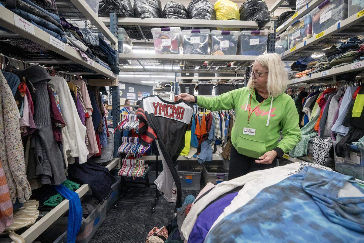 Mary Christ of Overland Park, a volunteer at the Starfish Project-a nonprofit providing essential items free of charge to those in need-sorts donations on Feb. 12, 2026, at the organization's Olathe location. Due to high demand, volunteers restock the entire store three times a day.