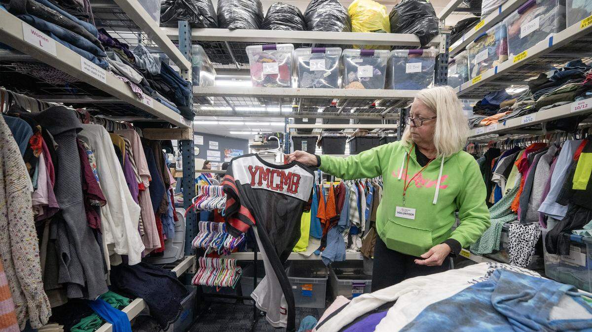 Mary Christ of Overland Park, a volunteer at the Starfish Project-a nonprofit providing essential items free of charge to those in need-sorts donations on Feb. 12, 2026, at the organization's Olathe location. Due to high demand, volunteers restock the entire store three times a day.