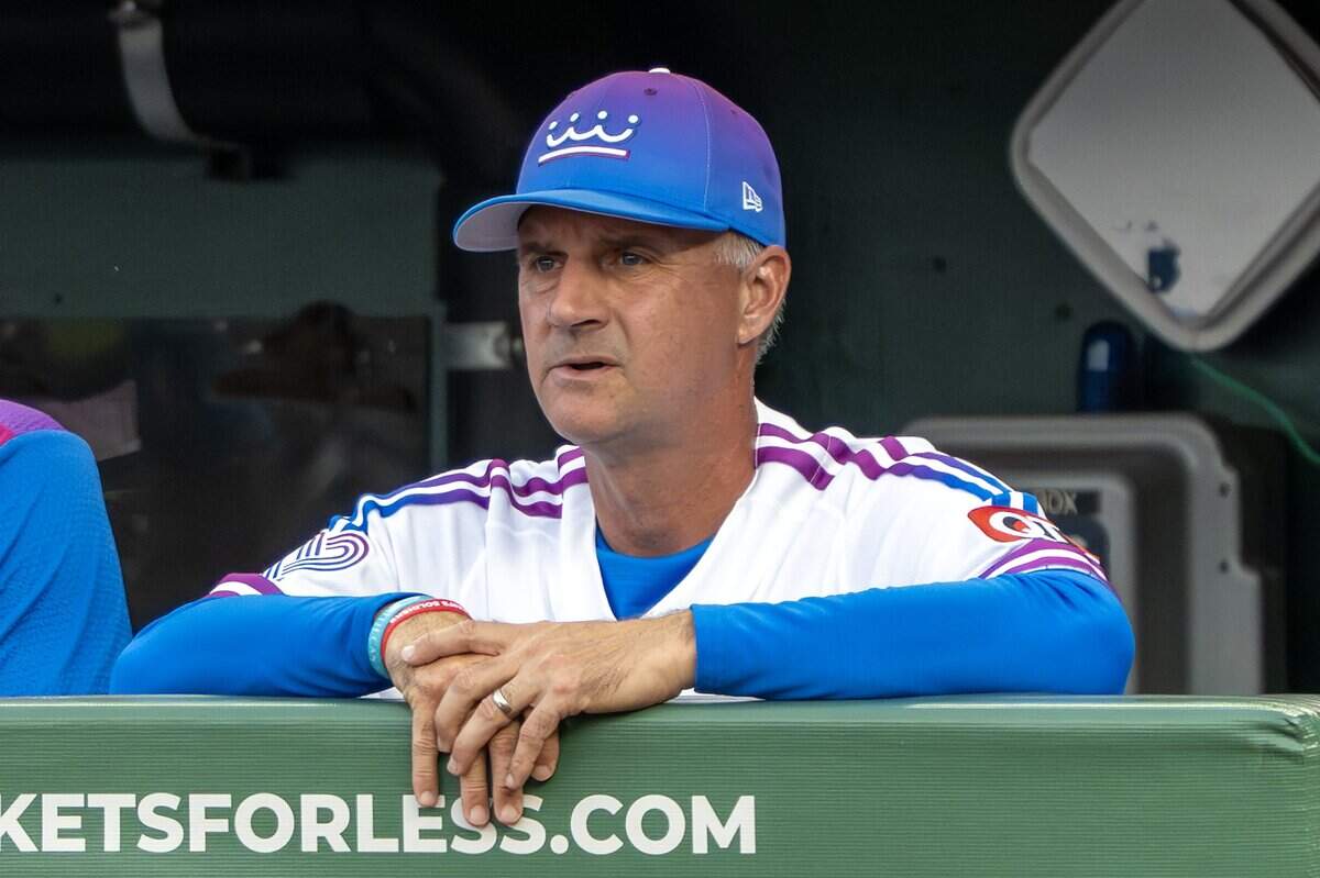 Wearing the Kansas City Royals' new "Forever Fountains" City Connect uniform, manager Matt Quatraro (33) watches from the dugout during the first inning of a game against the Houston Astros on Friday, June 12, 2026, at Kauffman Stadium in Kansas City.