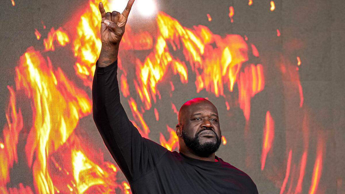 Shaquille O’Neal holds up the sign of the horns during a DJ performance ahead of the College Football Playoff semifinal game between the Texas Longhorns and Ohio State in the Cotton Bowl at AT&T Stadium on Friday, Jan. 10, 2024 in Arlington, Texas.