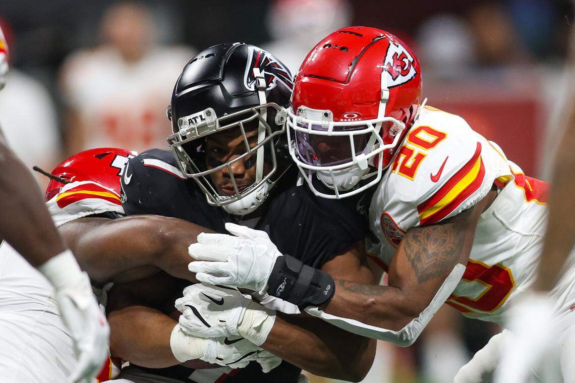Kansas City Chiefs safety Justin Reid (right) brings down Atlanta Falcons running back Bijan Robinson during Sunday night’s game at Mercedes-Benz Stadium.