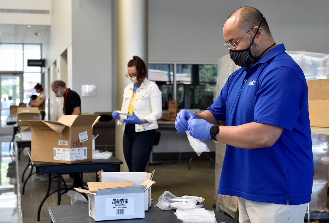 To prepare for the start of the fall semester under COVID-19, socially distanced University of Missouri-Kansas City staff, including Joe Constantino, director of external relations, assembled thousands of welcome back kits containing a mask, hand sanitizer and a card with safety reminders Wednesday in the student union.
