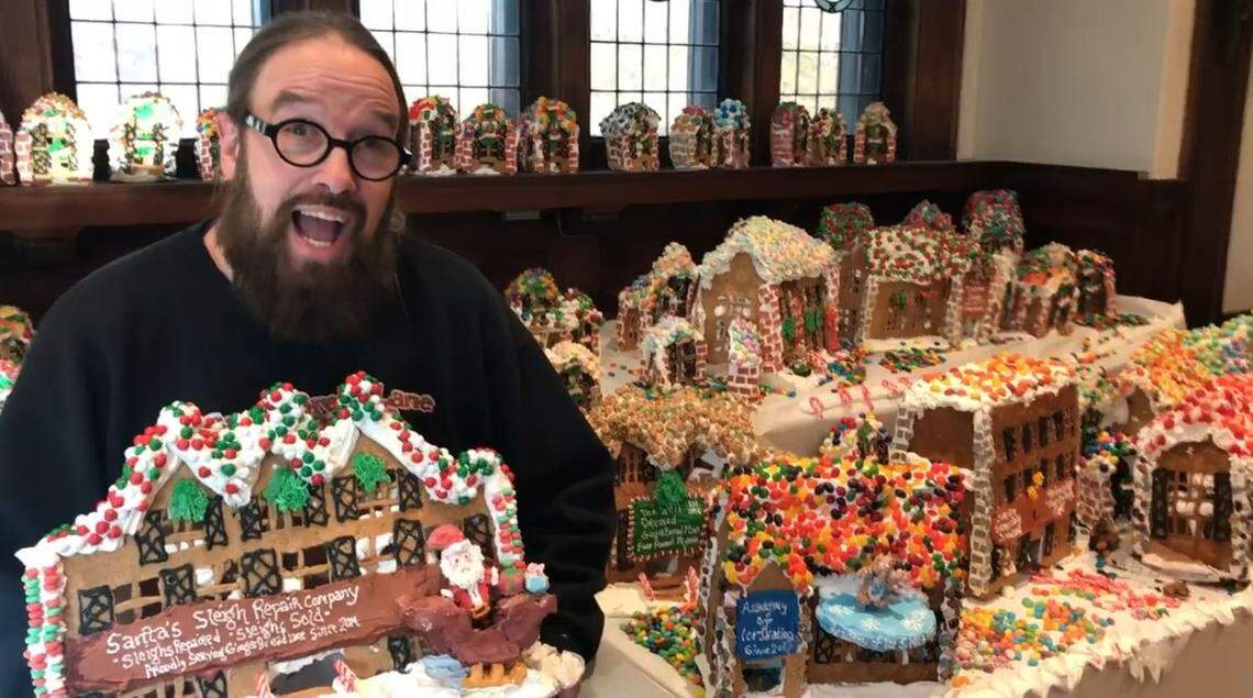 Artist Jon Lovitch, 46, holds a gingerbread house at the National Museum of Toys and Miniatures in Kansas City on Monday, Jan. 16, 2022. After his Gingerbread Lane exhibit closed the previous day, he gave away many of the structures that made up the edible village to local children.