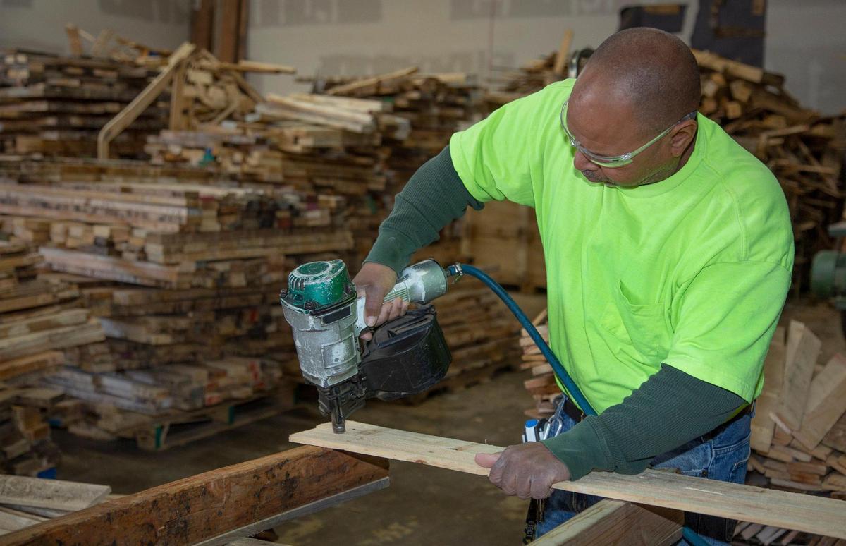Chuck Ellis working at his shipping pallet construction and refurbishing business. 5510 E 31st Kansas City. Ellis received a loan from Holy Rosary Credit Union through it’s Dream Builder’s loan program.